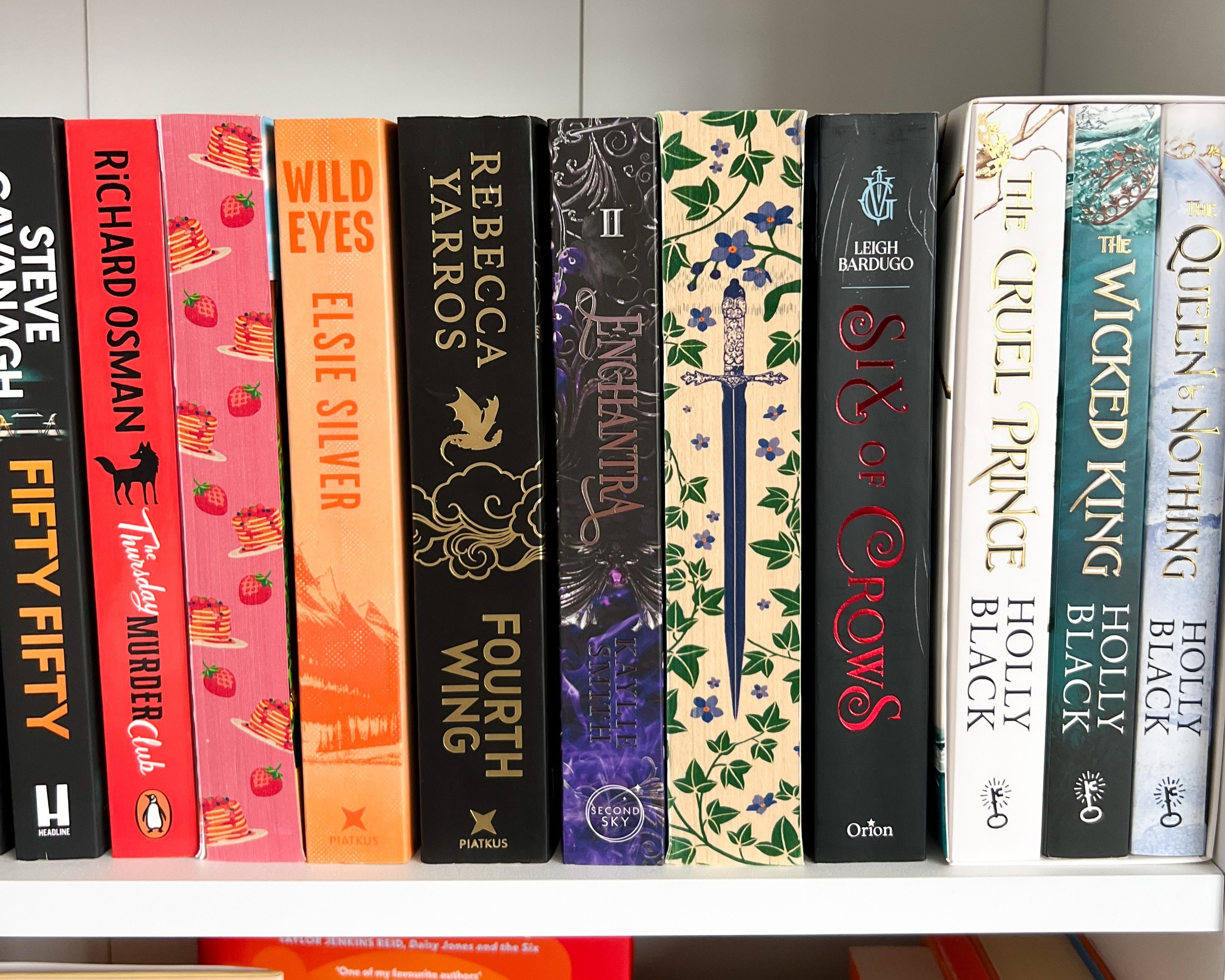 A photo of popular books with popular topes on a bookshelf.