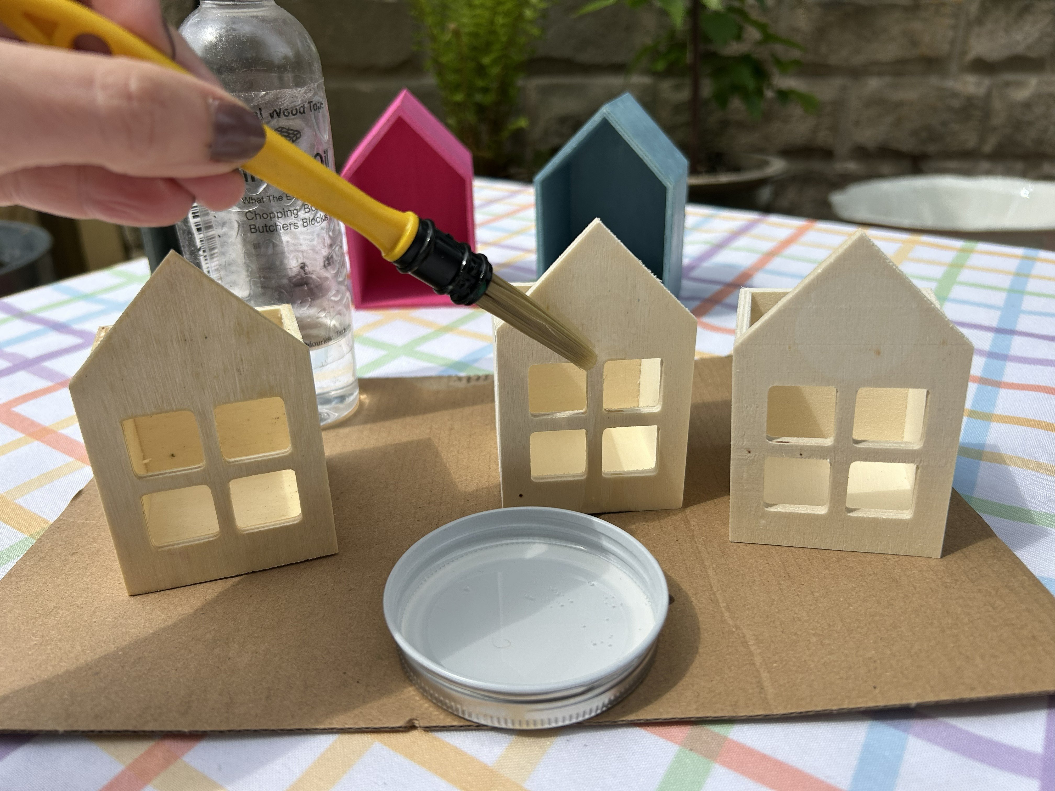 DIY Bug Hotel Three small wooden houses brushed with mineral oil.