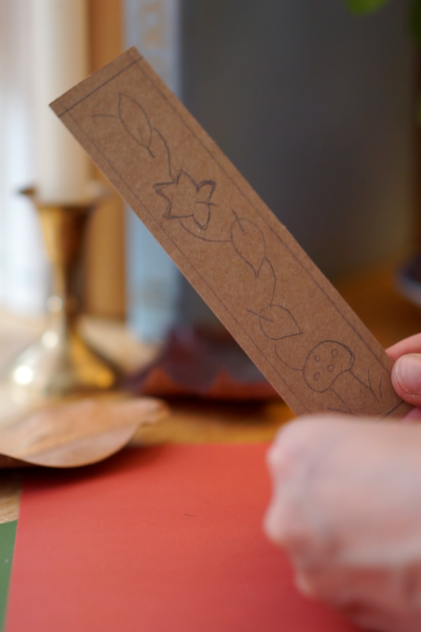 Pencil sketching of leaves and a mushroom on one of the pieces of card.