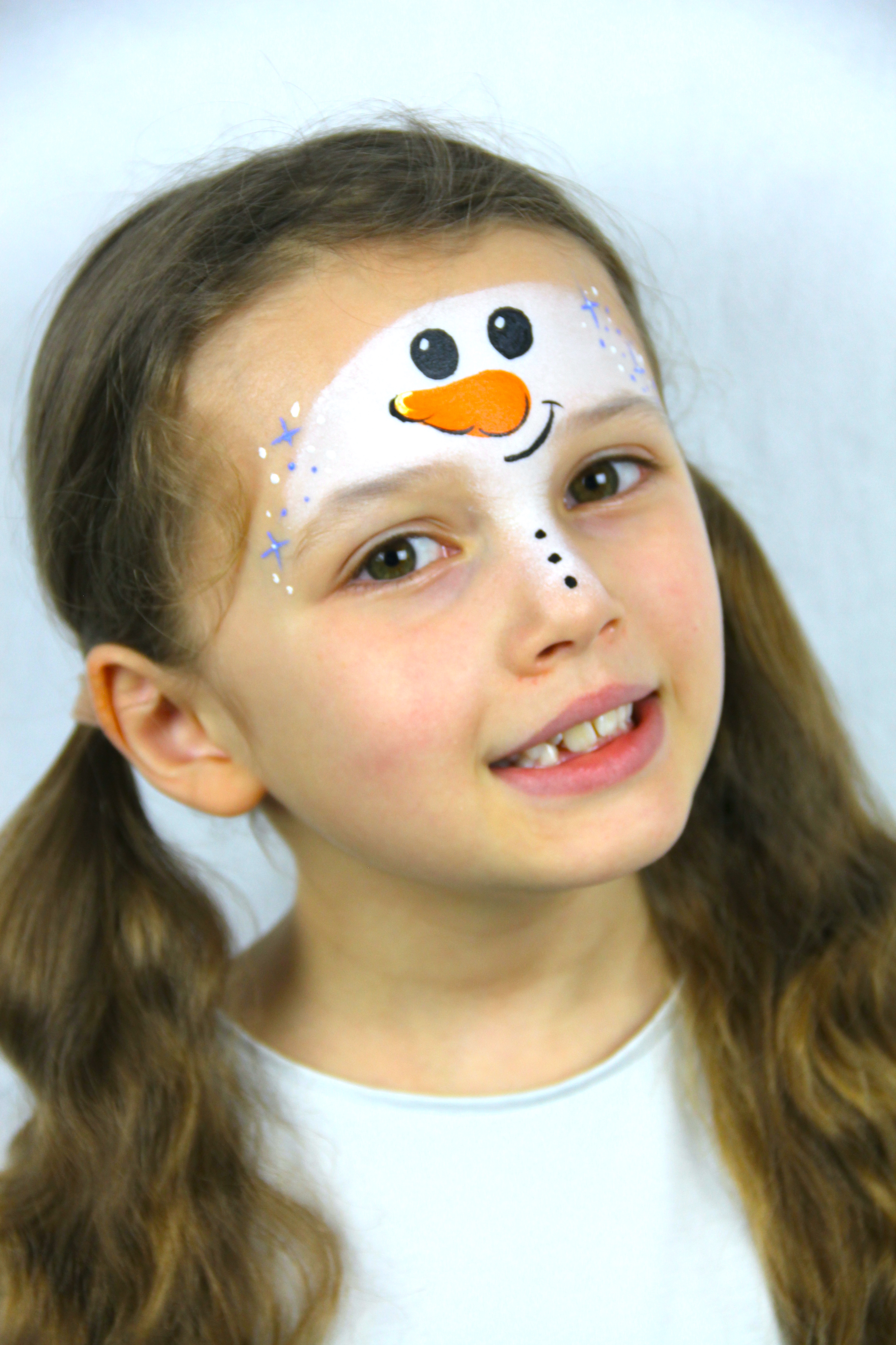 Add some small stars to each side of the face using blue paint.
