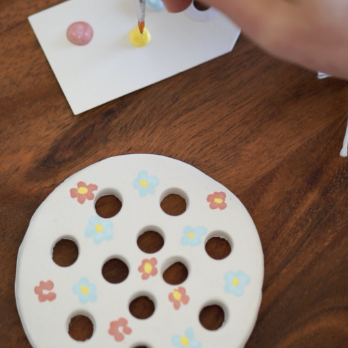 Painted flowers on the flower frog.