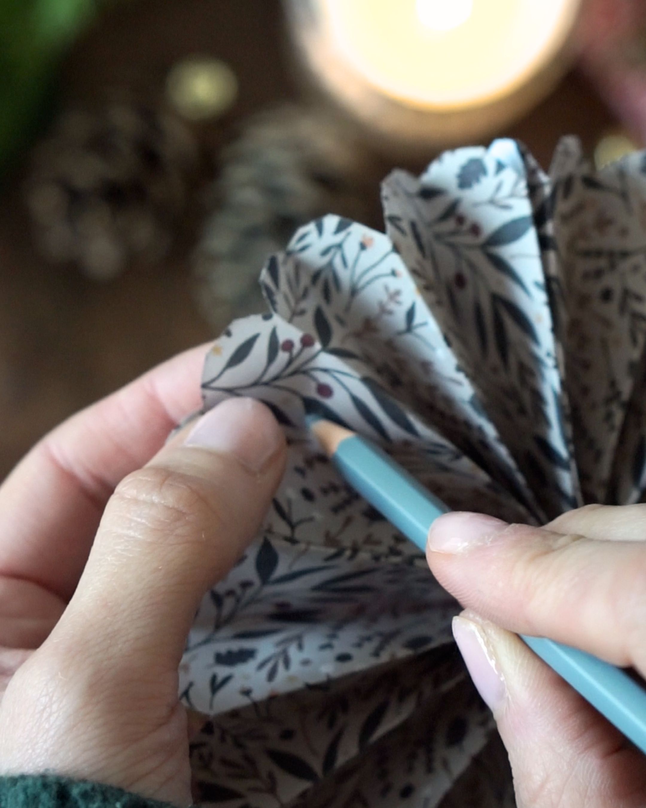 DIY Paper Fan Rosette Step 5 Punch a hole to hang it.