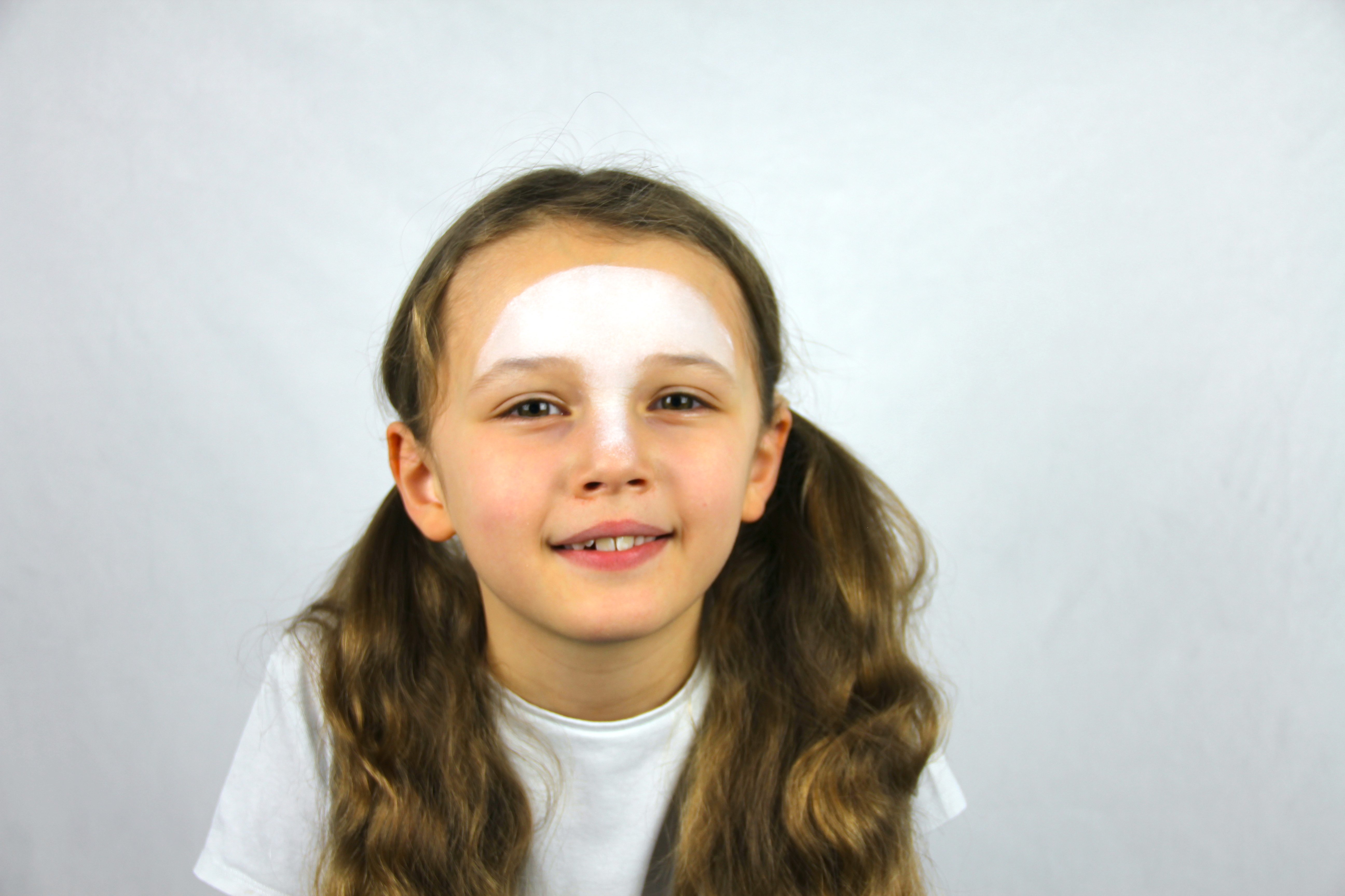 Sponge white paint across the forehead and nose.