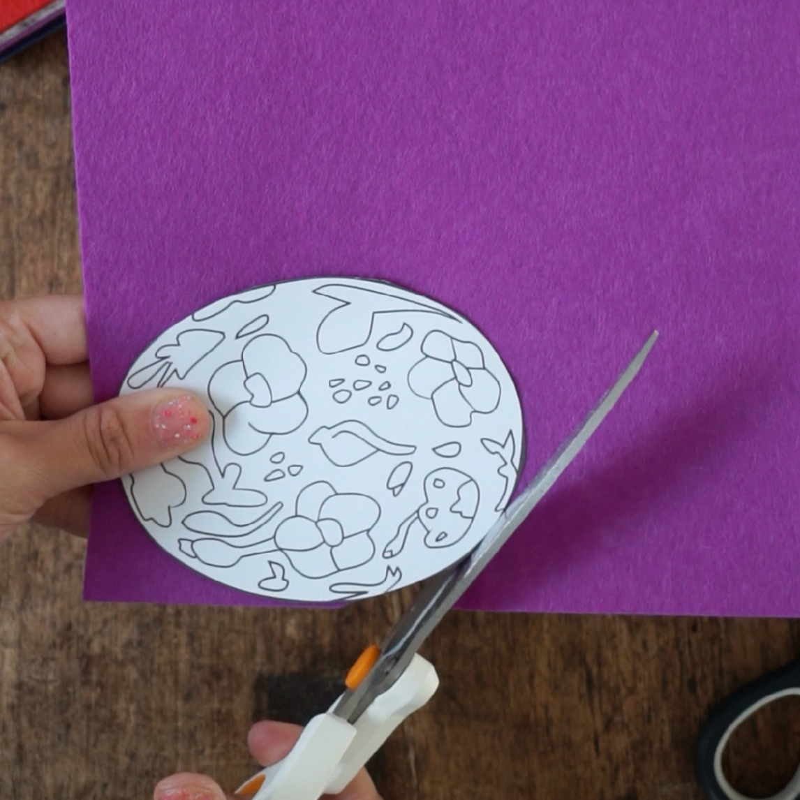 Step 2: Start with the Largest Shape Scissors cutting out felt around the shape form the colouring page.#