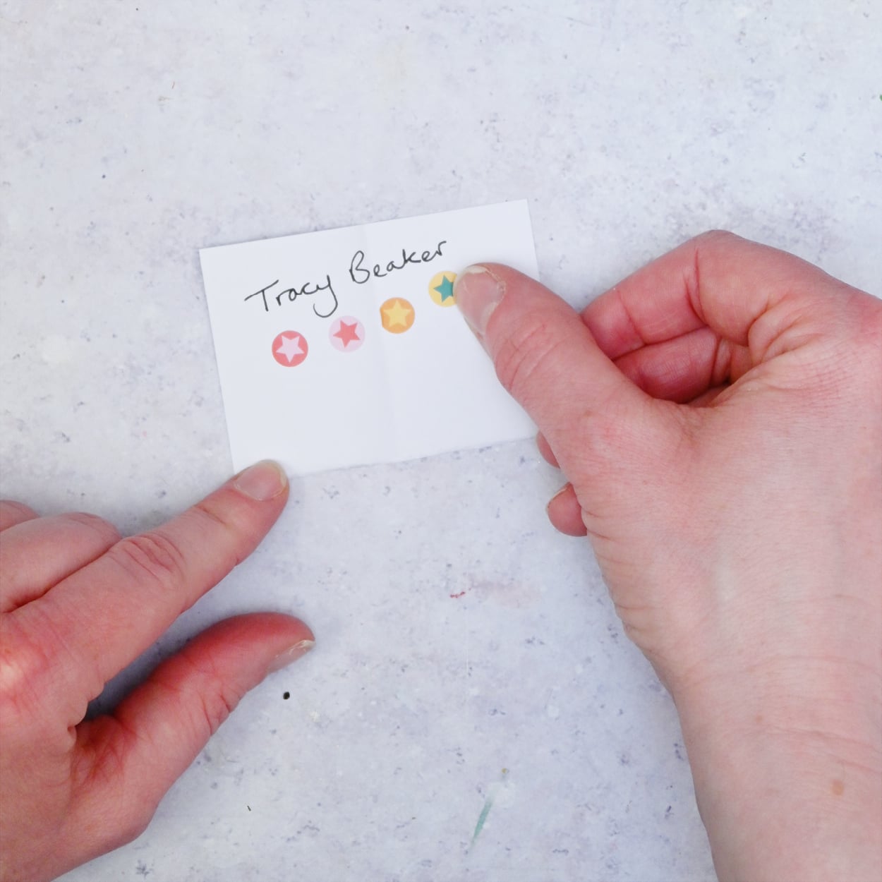 DIY TBR Book Jar A piece of paper with four stickers and Tracy Beaker written on it.