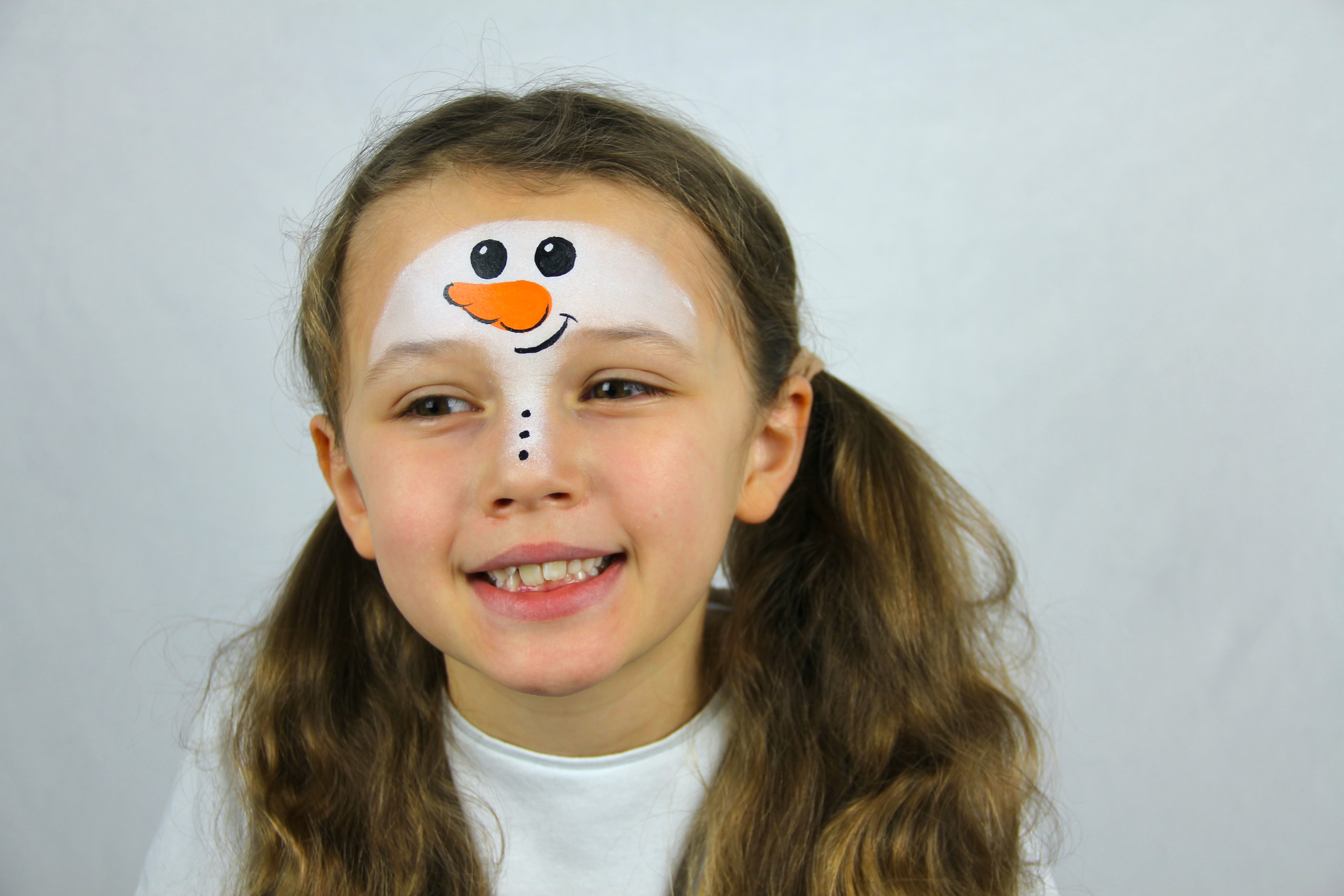 Paint in the snowman's eyes, mouth, and coal buttons with black paint and a nose with orange.