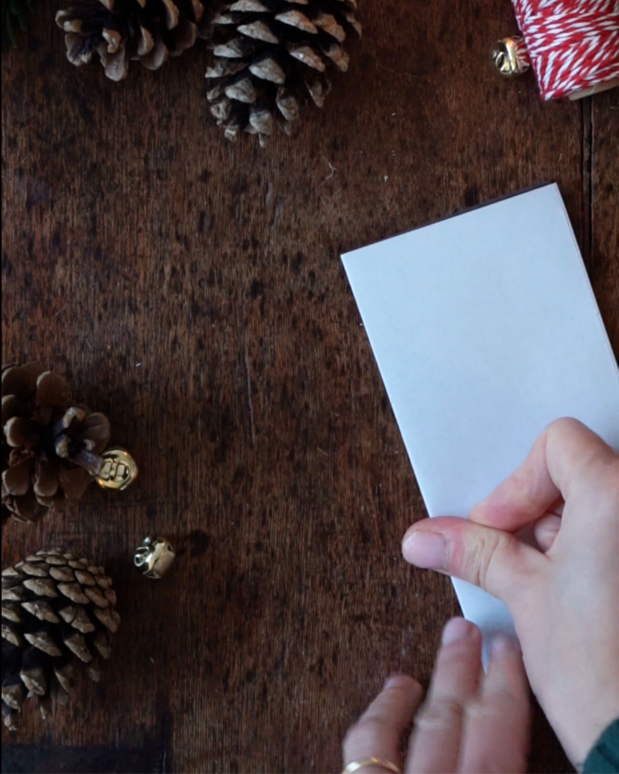 DIY Paper Bell Ornaments Step 1 Folded piece of paper.