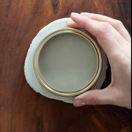 Circular object over clay.