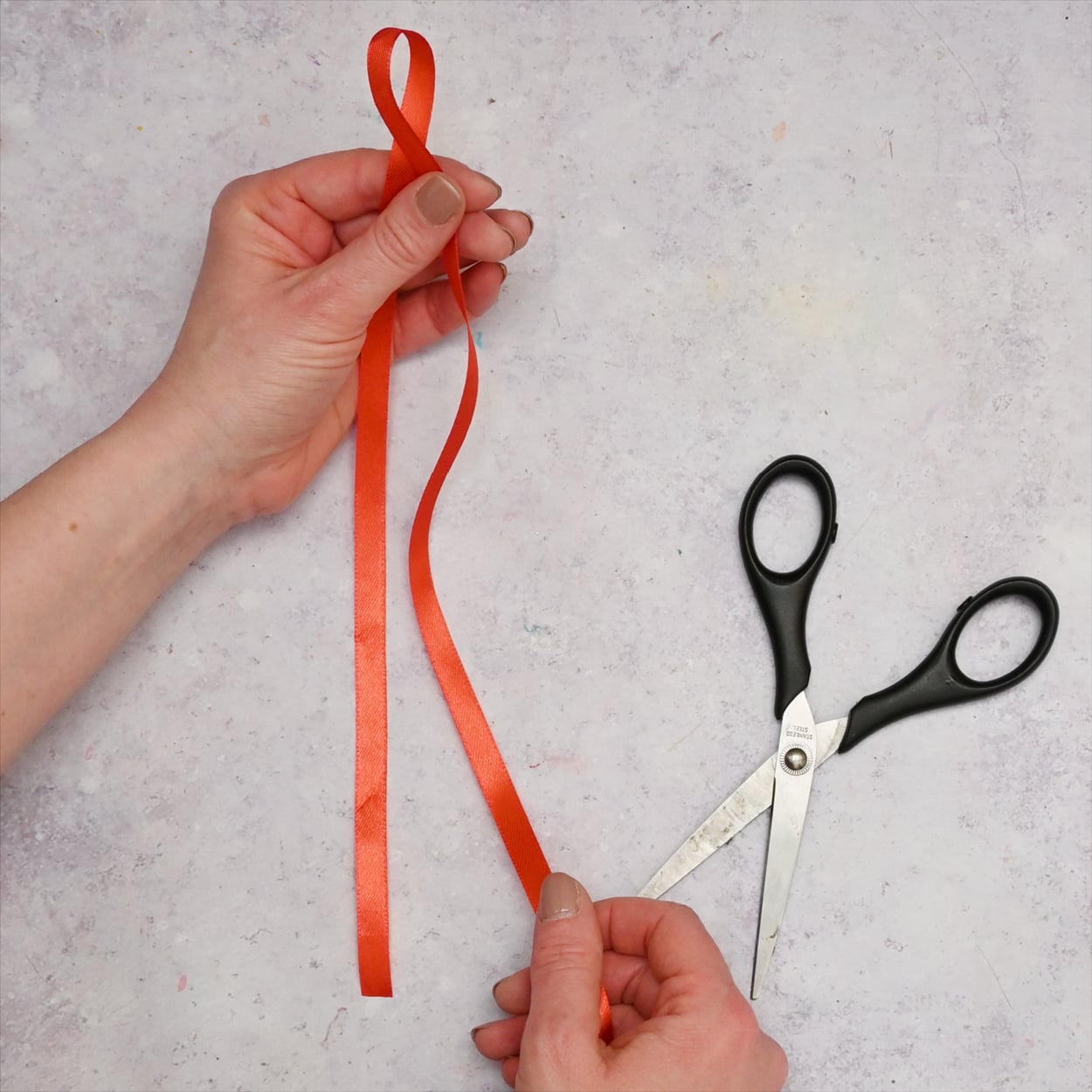 Red ribbon and some scissors.