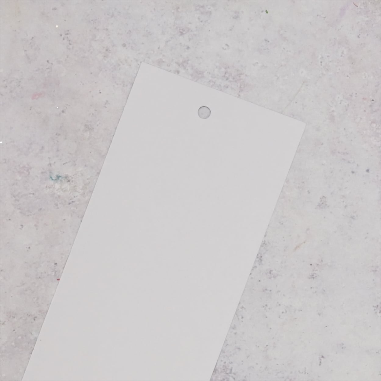 Card with hole punched in the top.