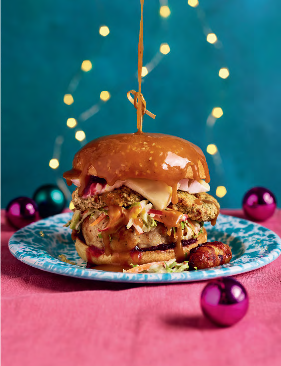 The Ultimate Christmas Burger Festive air fryer Christmas burger stacked with turkey patty, stuffing, pigs in blankets, Brie, and cranberry sauce in a toasted brioche bun