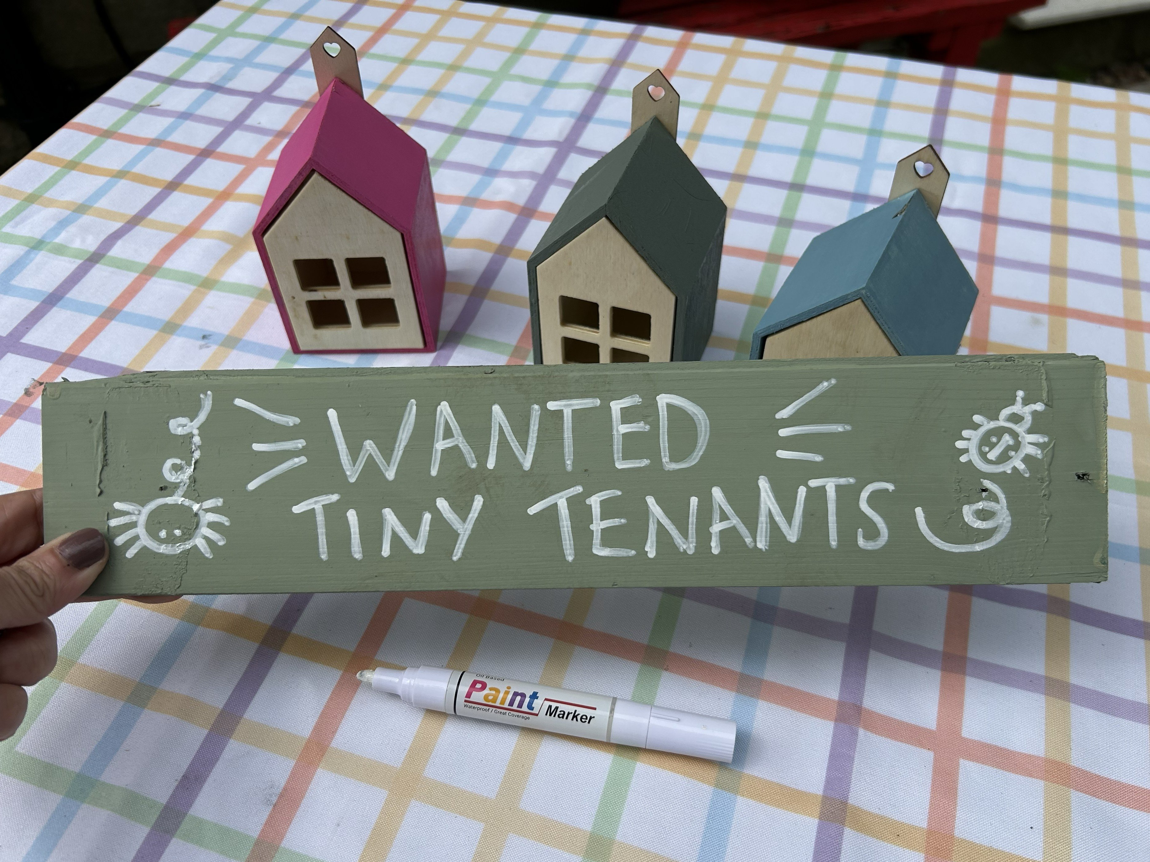 DIY Bug Hotel Wooden sign that says 'Wanted Tiny Tenants'.