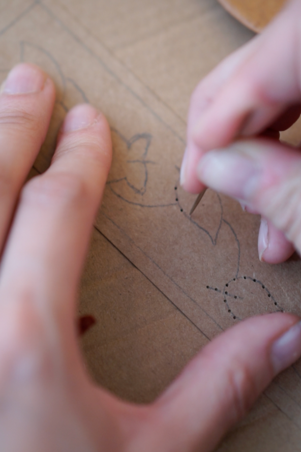 Autumn Embroidered Bookmark Step 4 Close up shot of poking holes with a needle to outline the design.
