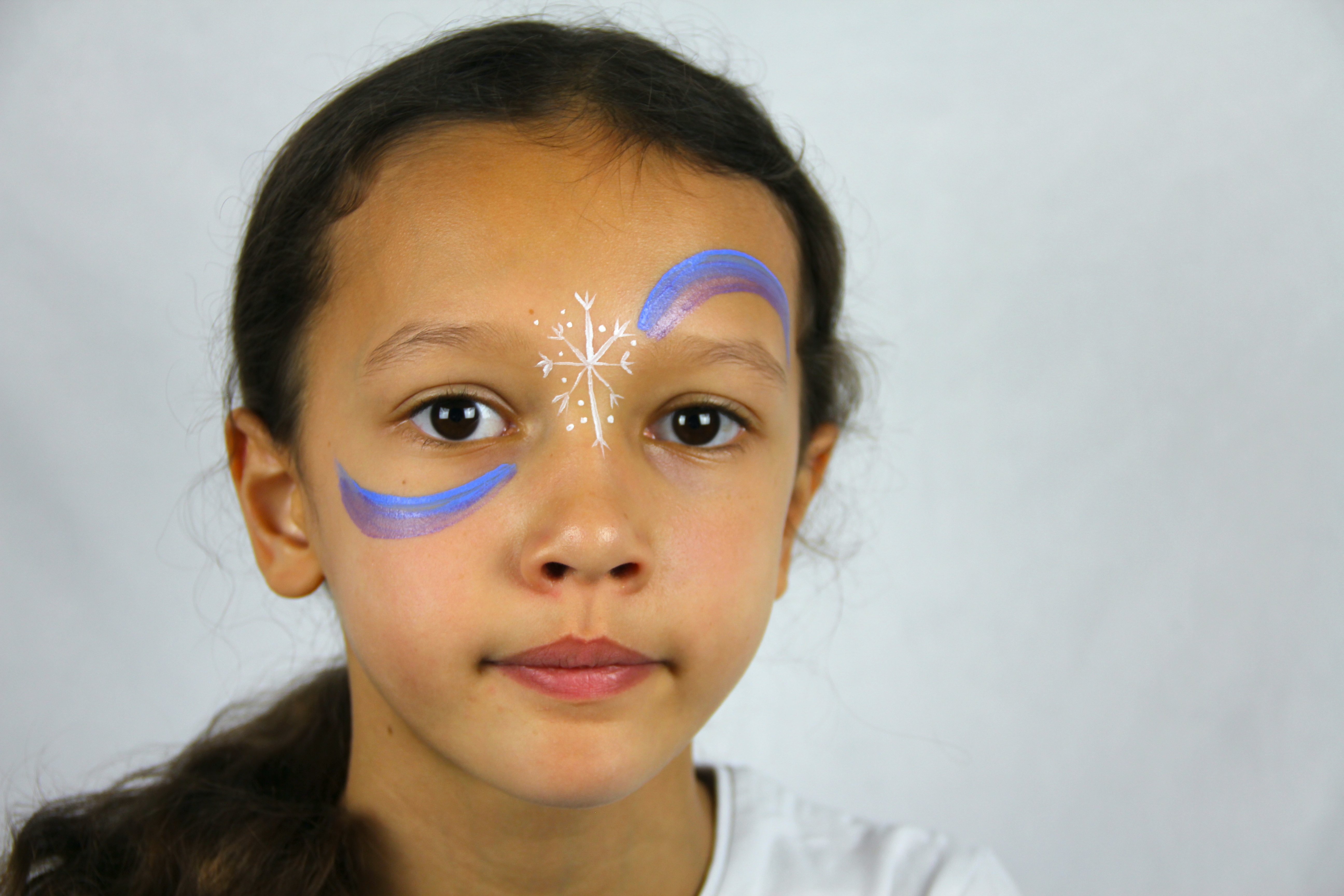 Create swirls of blue, purple, and white by painting a crescent shape over one eye and under the other eye.
